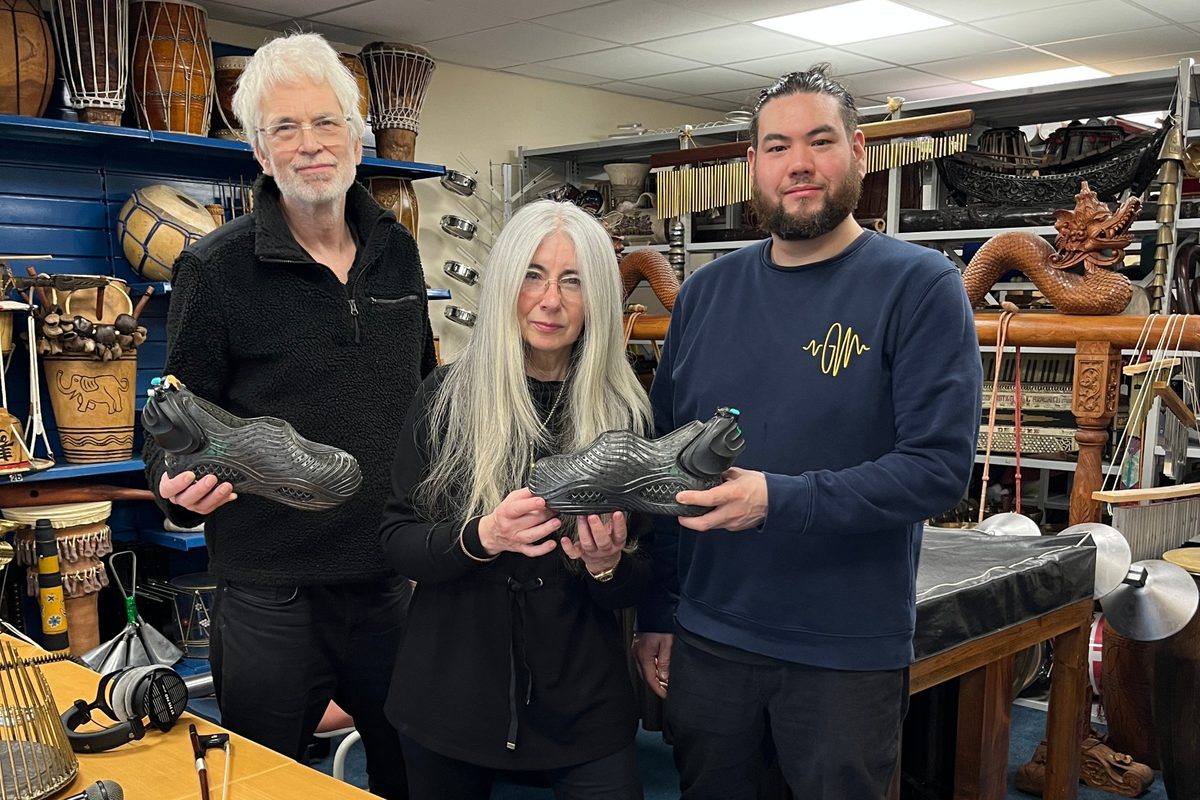 Ben Hurdle, Dame Evelyn Glennie and Nick Inoue holding the GroundWaves shoes